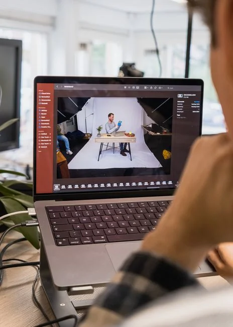 A stylish workspace featuring a laptop and monitors displaying design software.